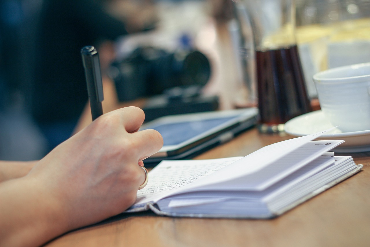 Hand writing a personal note in a journal
